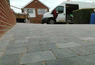 A concrete driveway uplifted, groundwork prepared and a bradstone woburn rumbled graphite pavior in three different sizes laid at a job in Carlton, Nottingham
