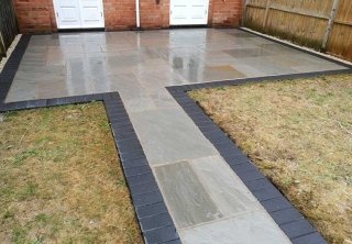 A rear patio we created in Radcliffe on Trent (Nottinghamshire) using a charcoal pavior border with a kandla grey indian sandstone. We also turfed the grassed area. A rear patio we created in Radcliffe on Trent (Nottinghamshire) using a charcoal pavior border with a kandla grey indian sandstone. We also turfed the grassed area.