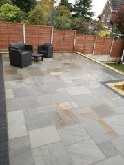 A full rear landscape involving retaining wall using sleepers, patio using a charcoal edging pavior, a kandla grey indian sanstone and grass area returfed at a job in Gedling, Nottingham A full rear landscape involving retaining wall using sleepers, patio using a charcoal edging pavior, a kandla grey indian sanstone and grass area returfed at a job in Gedling, Nottingham