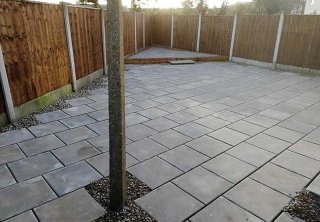 A rear patio we installed using plain grey 450x450 slabs for a job in Carlton, Nottingham A rear patio we installed using plain grey 450x450 slabs for a job in Carlton, Nottingham